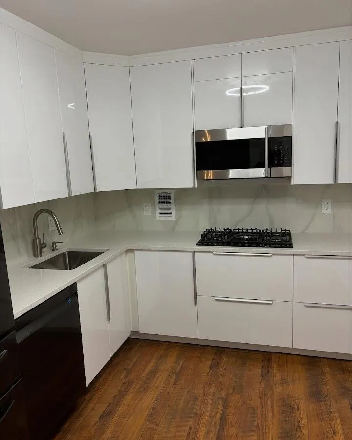 Restored kitchen with white cabinets after water damage in Oyster Bay